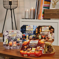 Edle Tropfen în Nuss Vodka Lounge 100g, praline de ciocolată umplute cu lichid, cu glazură de ciocolată cu lapte și bucăți crocante de alune de pădure