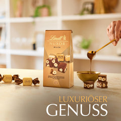 Ciocolată Lindt | Pliculeț de ciocolată cu lapte NUXOR | 103g | Cuburi cremoase de ciocolată cu lapte Gianduja cu alune de pădure prăjite | Cadou de ciocolată