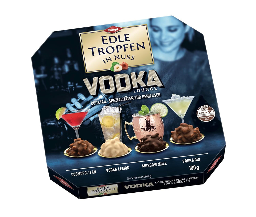 Edle Tropfen în Nuss Vodka Lounge 100g, praline de ciocolată umplute cu lichid, cu glazură de ciocolată cu lapte și bucăți crocante de alune de pădure