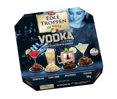 Edle Tropfen în Nuss Vodka Lounge 100g, praline de ciocolată umplute cu lichid, cu glazură de ciocolată cu lapte și bucăți crocante de alune de pădure